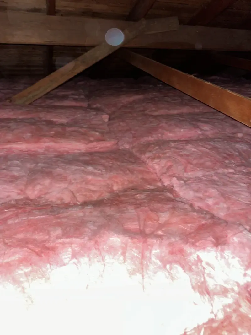 Fiberglass batts installed across an attic floor