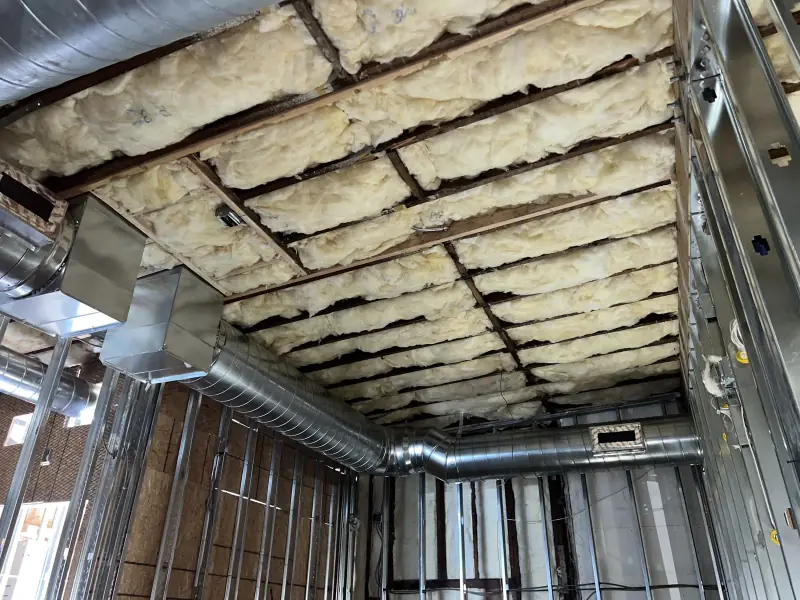 Commercial ceiling with insulation installed between beams