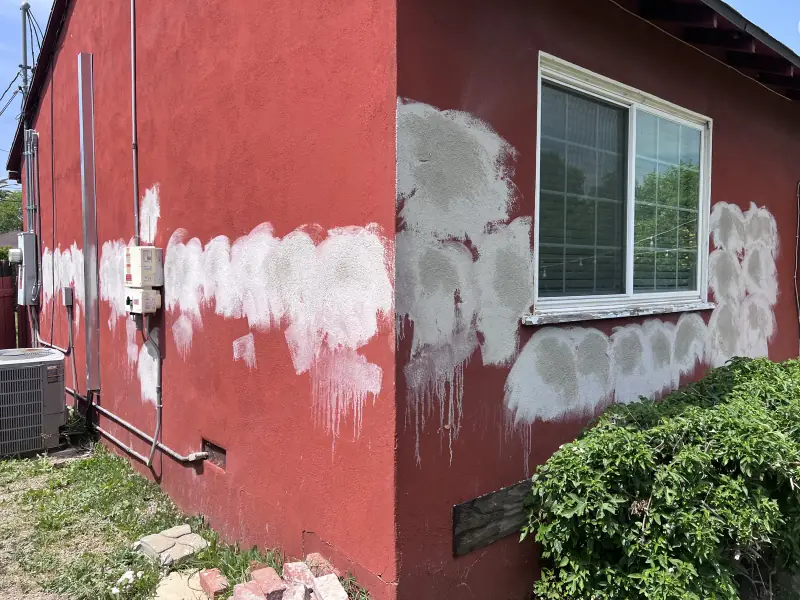 Exterior wall patched after drill and fill insulation